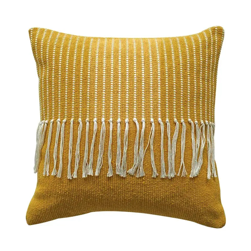A mustard-yellow woven boho moroccan fringed pillowcase with textured pattern and white fringe for living room decor