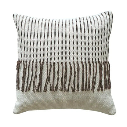 A boho moroccan fringed pillowcase with textured weave black dotted stripes off-white background and brown fringe edge