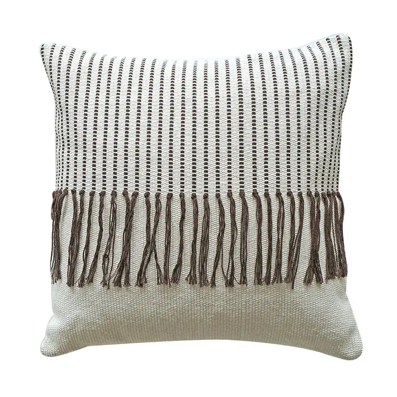 A boho moroccan fringed pillowcase with textured weave black dotted stripes off-white background and brown fringe edge