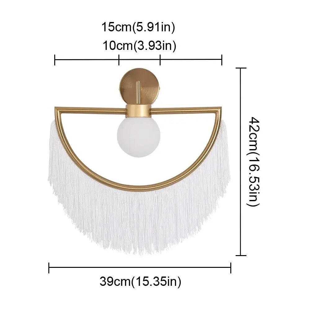 Gold-toned glass ball pendant light with frosted globe and white fringe for boho bedroom pendant light decor
