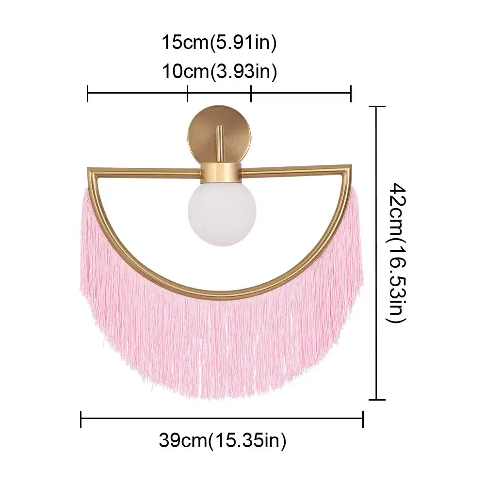 A modern semi-circular ball pendant light with a gold frame pink fringe tassels and frosted glass globe for bedroom