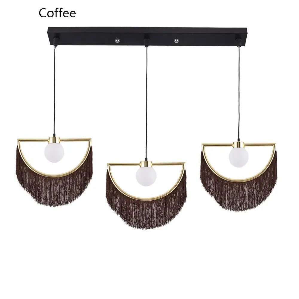 Set of three boho pendant lights with gold-toned frames, white glass ball pendants, and dark brown fringe accents for bedroom