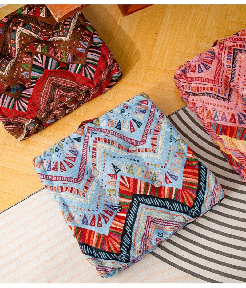 Boho multi color square floor pillows with vibrant geometric embroidery on light fabric for living room seating cushions