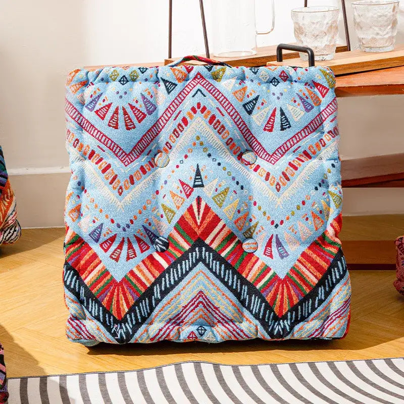 Boho multi color quilted square floor pillows with vibrant blue red and black geometric patterns for living room seating