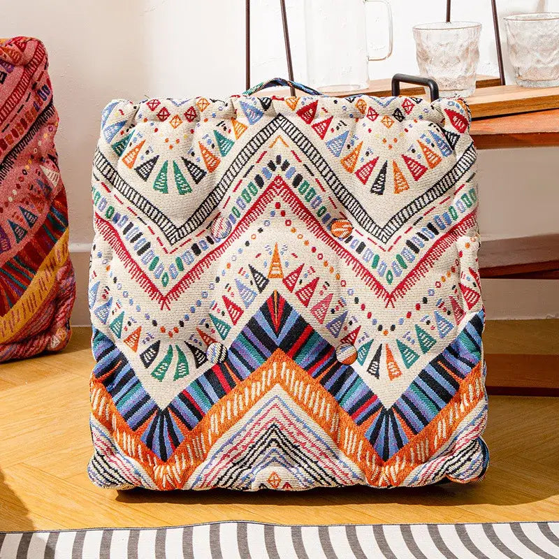 Vibrant geometric-patterned canvas drawstring bag with multicolored triangular and zigzag designs for floor pillows