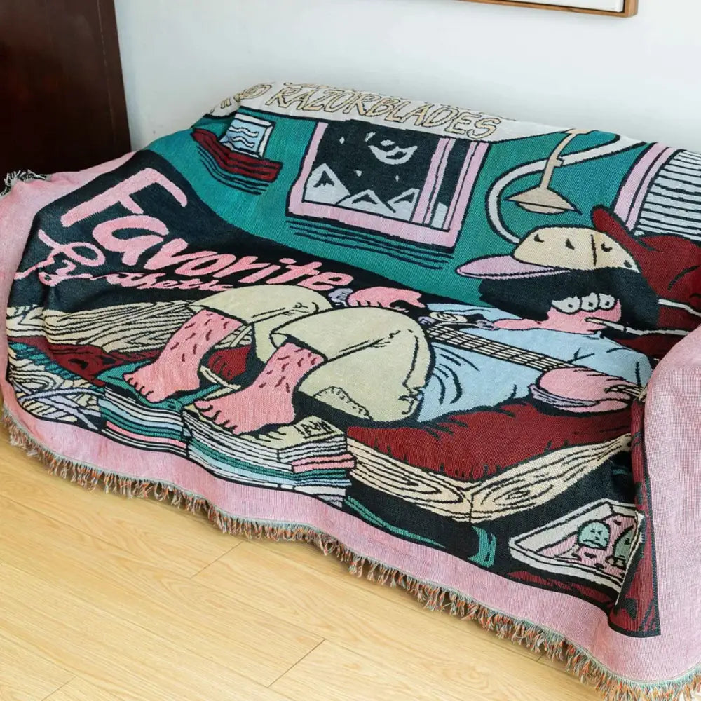 A cozy pink-fringed woven guitar boy throw blanket with vibrant cartoon design for living room decorbites guitar boy decor