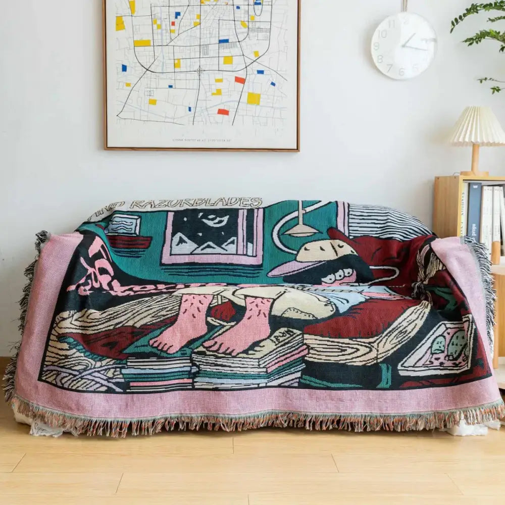 A cozy boho multicolored woven guitar boy throw blanket featuring cartoon feet on books and razorblades text decorbites guitar boy