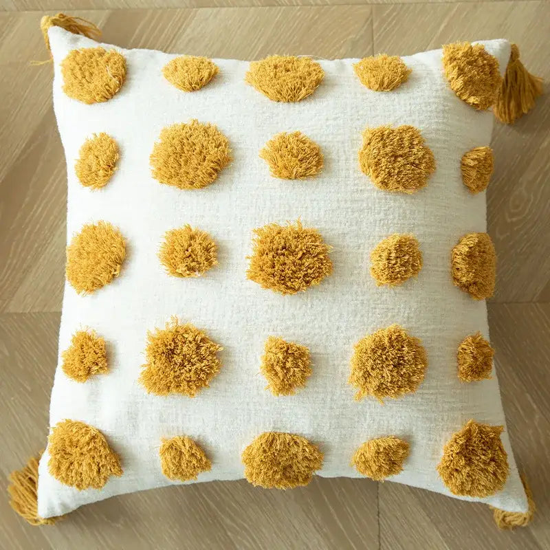 Cream-colored cushion cover with mustard-yellow pom-poms and tassels boho decorbites geometric tufted accent