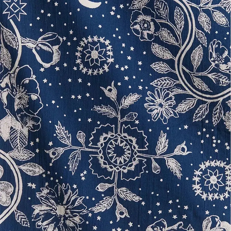 Boho navy blue celestial floral moon phase tapestry with deep blue fabric and intricate white floral moon phase patterns