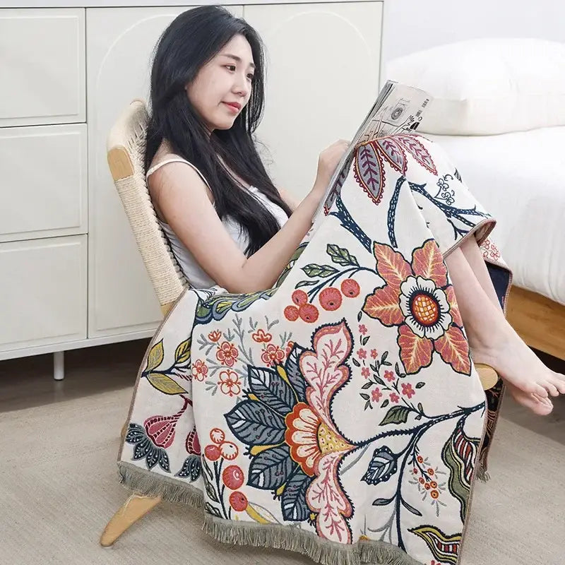 A cozy cream-colored cotton bath towel with vibrant orange pink and blue floral pattern for boho bathroom decorbites decor