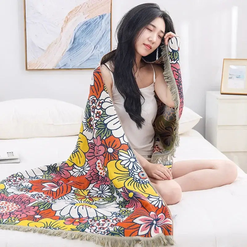 A vibrant multicolored cotton bath towel with fringe trim featuring boho navy and yellow floral decorbites design