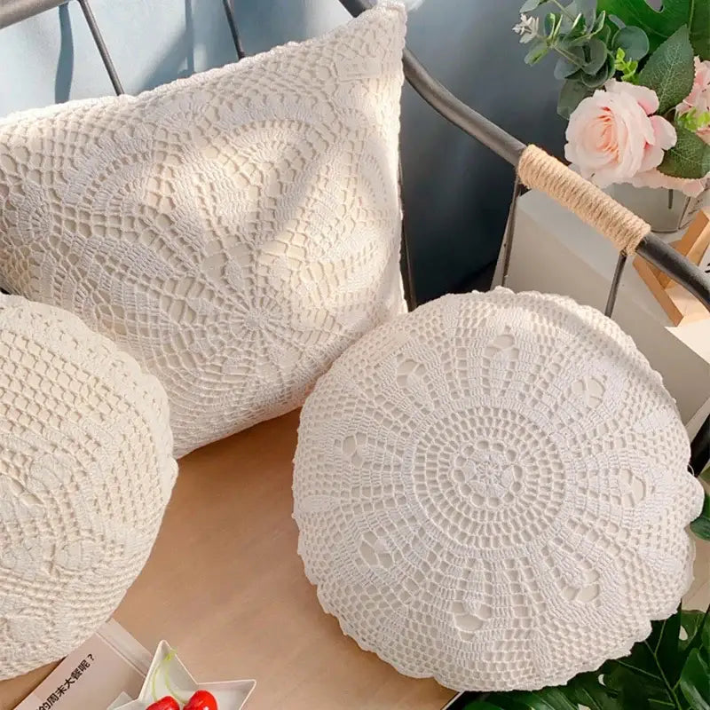 Cream-colored decorbites crochet cushion cover with intricate floral lace pattern and scalloped edges for living room decor