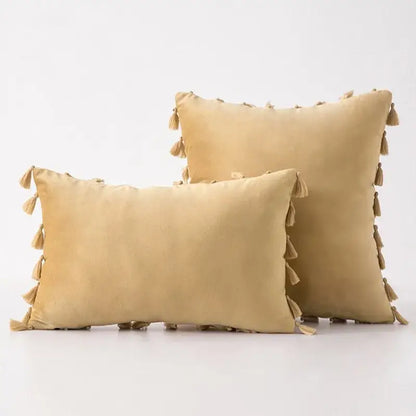 Beige suede throw pillow covers with tassel fringe perfect for boho home decor and living room accents