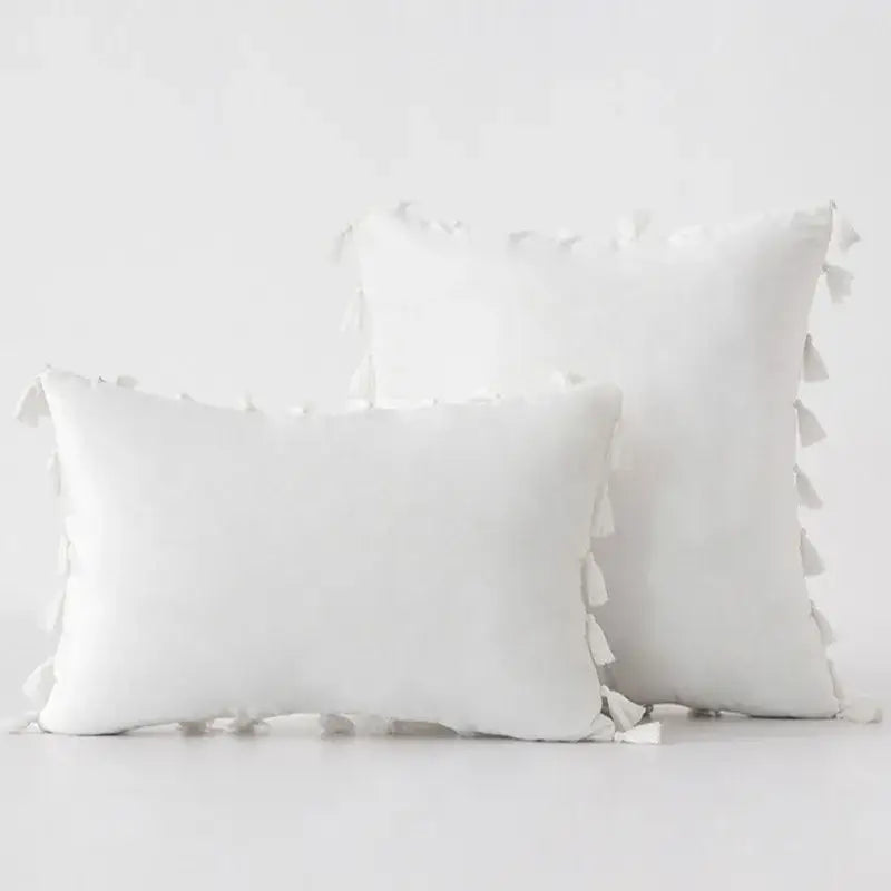 White rectangular pillow covers with soft textured fabric and tassel fringe for boho home decor living room accents
