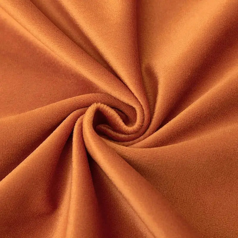 Rich rust-colored velvet pillow covers with tassel fringe featuring soft plush texture for boho home decor