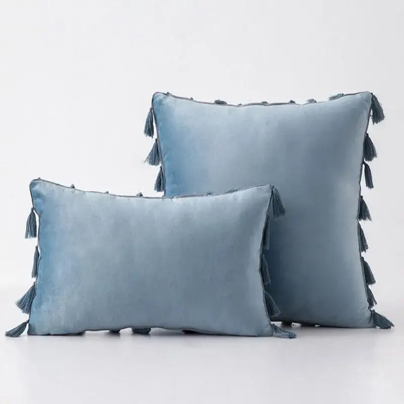 Soft blue velvet pillow covers with tassel fringe edges ideal for boho home decor and living room accents