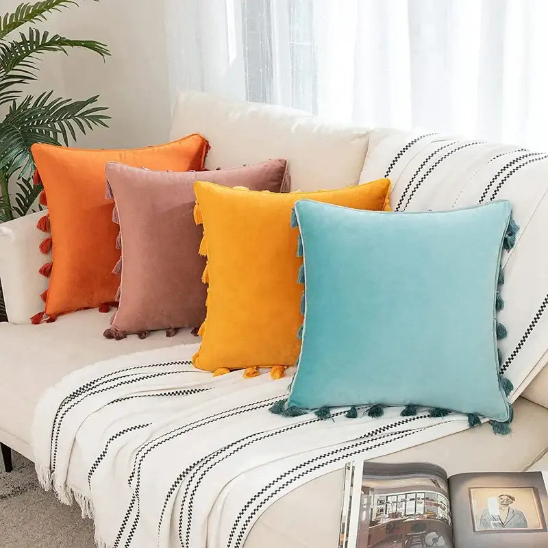 A soft teal velvet throw pillow with tassel fringe trim for stylish home decor and pillow covers use
