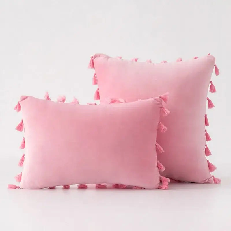 Soft pink velvet pillow covers with tassel fringe along edges ideal for boho home decor living room accents
