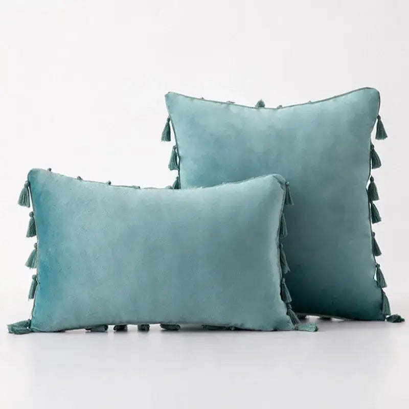 Teal suede throw pillow covers with matching tassel fringe edges for boho home decor living room accents