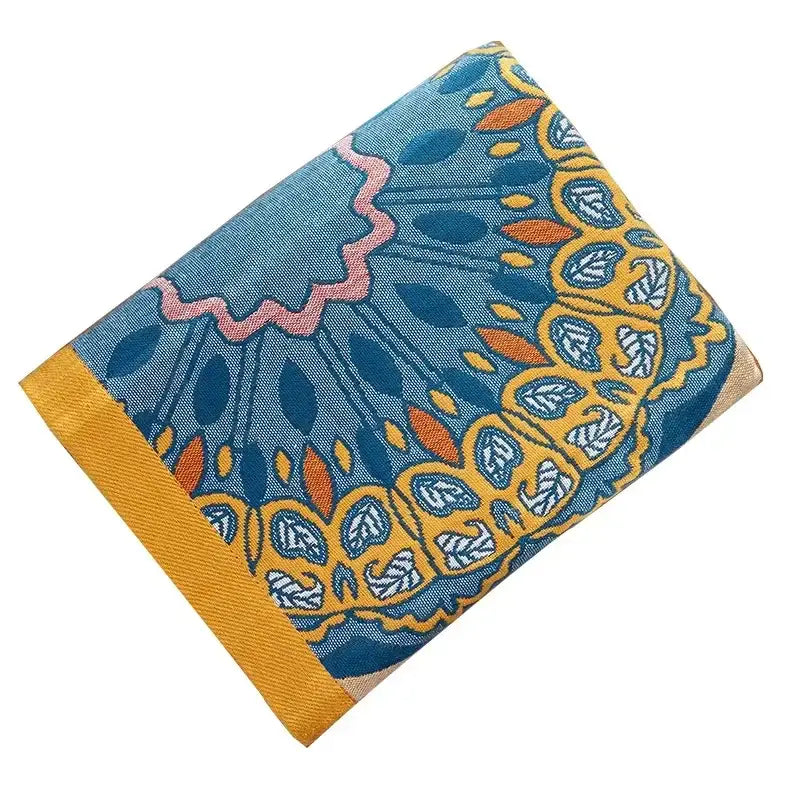 A vibrant blue and yellow paisley patterned cotton gauze bath towel by decorbites for stylish bathroom wrap use