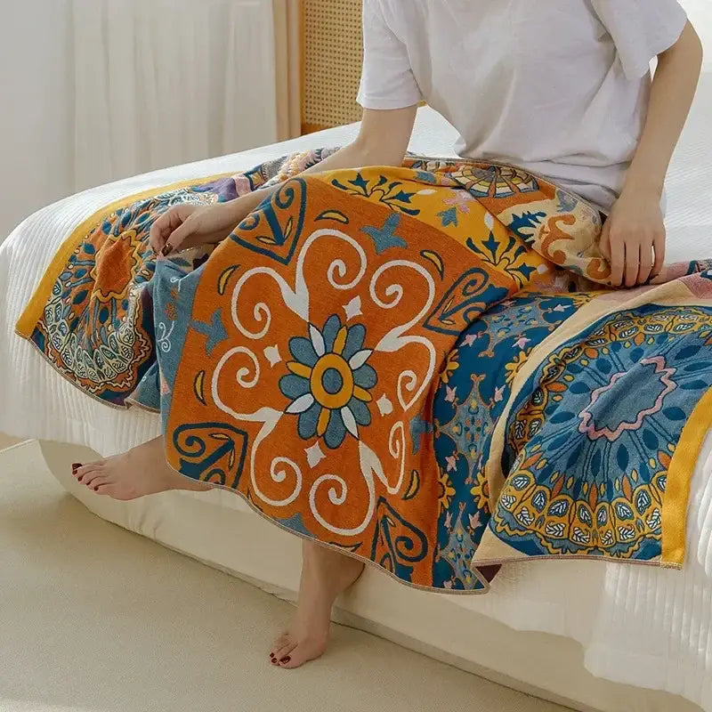 Vibrant orange and blue cotton gauze bath towel with intricate floral swirl design for boho bathroom decorbites cotton gauze