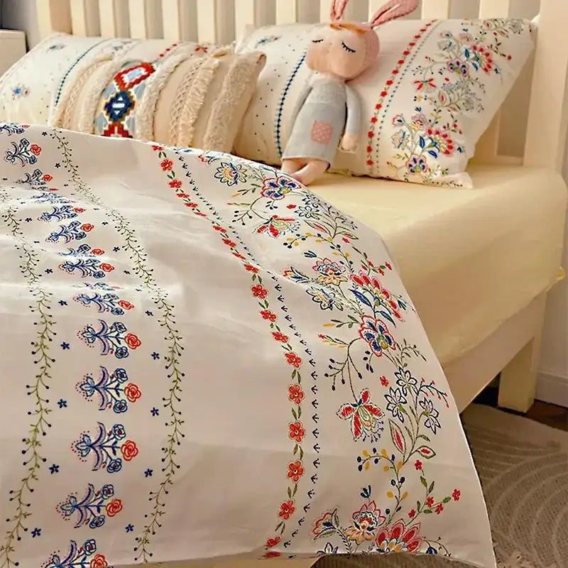 White duvet cover with intricate embroidered floral patterns in red blue and green from decorbites boho pattern printed bedding set