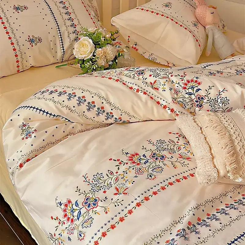 Cream-colored embroidered floral duvet cover with red blue and green threadwork in decorbites boho pattern printed bedding set