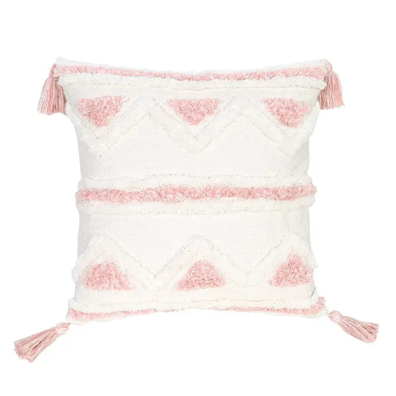 A soft white and pink woven boho pink geometric pillow cover with textured pattern and matching tassels for bedroom decorbites decor