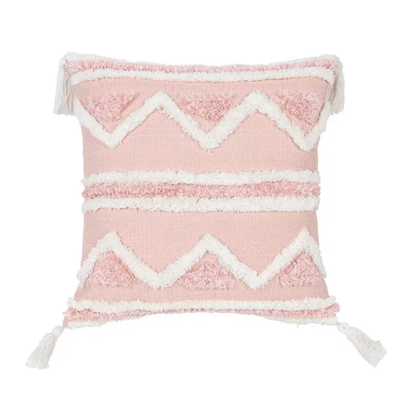 Boho pink geometric tufted pillow covers in pink and white woven fabric with zigzag patterns and tassels for bedroom decor