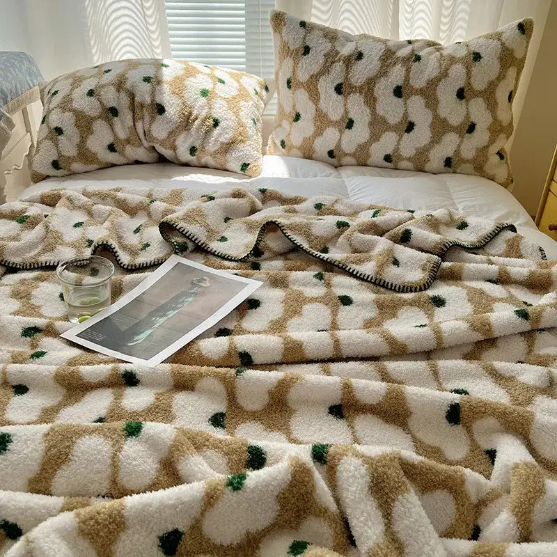 Fluffy beige and white boho printed blanket with green dot accents featuring soft plush texture for bedroom use