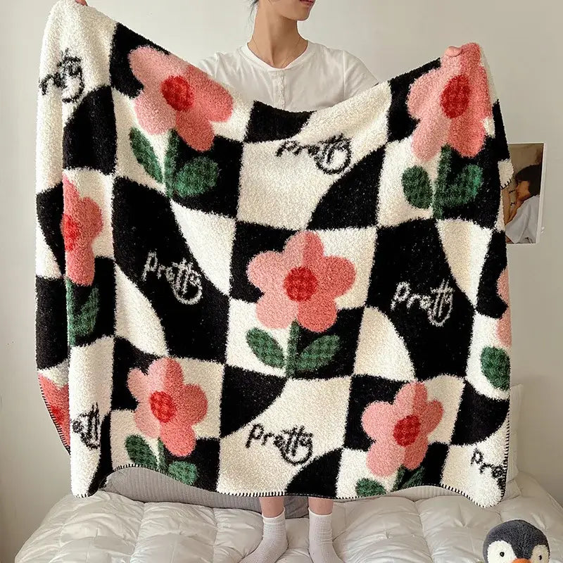 Boho printed blanket with black and white checkered pattern pink flowers green leaves and pretty cursive script design
