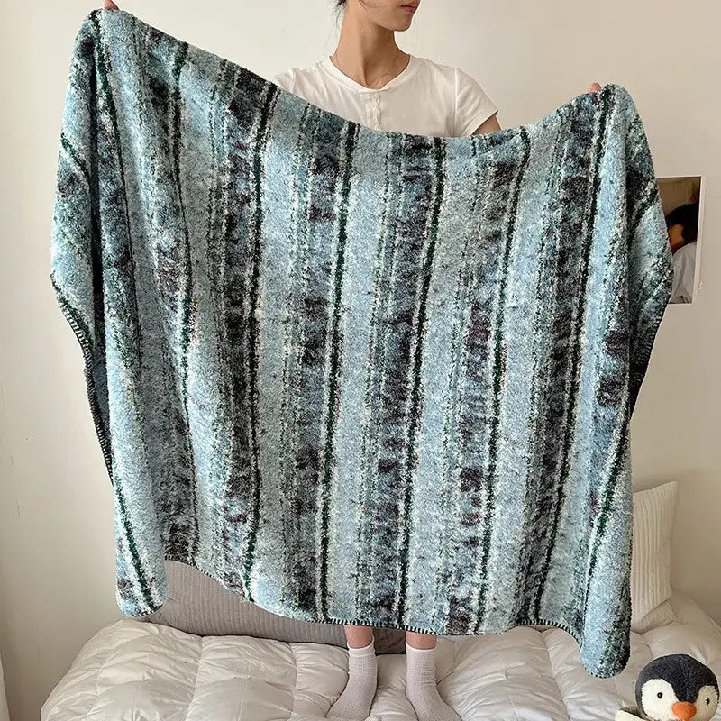 Soft boho printed blanket with chunky knit texture and teal and dark gray vertical stripes for bedroom use