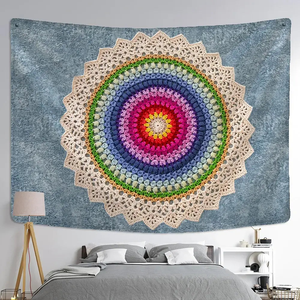 A vibrant hand-crocheted boho rainbow indian mandala wall hanging with cream lace border on textured blue wall decorbites indian mandala