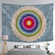 A vibrant hand-crocheted boho rainbow indian mandala wall hanging with cream lace border on textured blue wall decorbites indian mandala