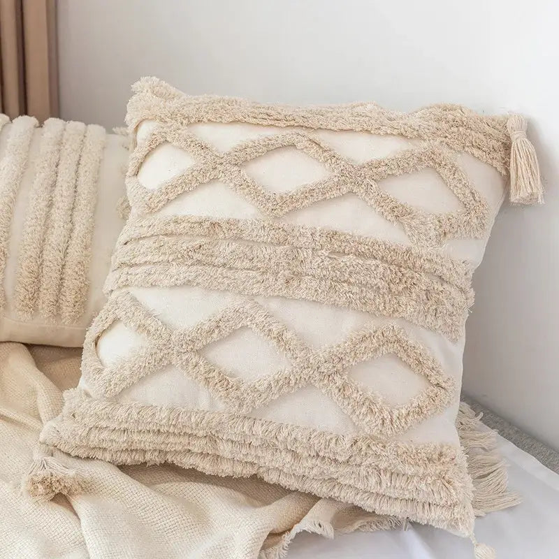 Cream-colored decorbites boho square pillowcase with textured fringed zigzag patterns and teal tassels for living room decor