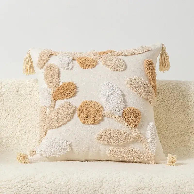 Cream-colored decorbites boho square pillowcase with textured embroidered leaf patterns and tassels for living room decor