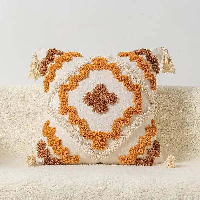Cream-colored decorbites boho square pillowcase with textured geometric pattern and mustard yellow and brown tassels