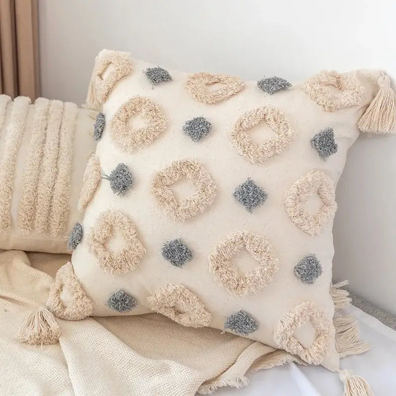 Cream-colored decorbites boho square pillowcase with beige and gray looped tassels and geometric patterns for living room decor