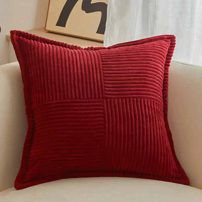 Red corduroy throw pillow with quilted patchwork design complements boho striped pillow covers for living room decor
