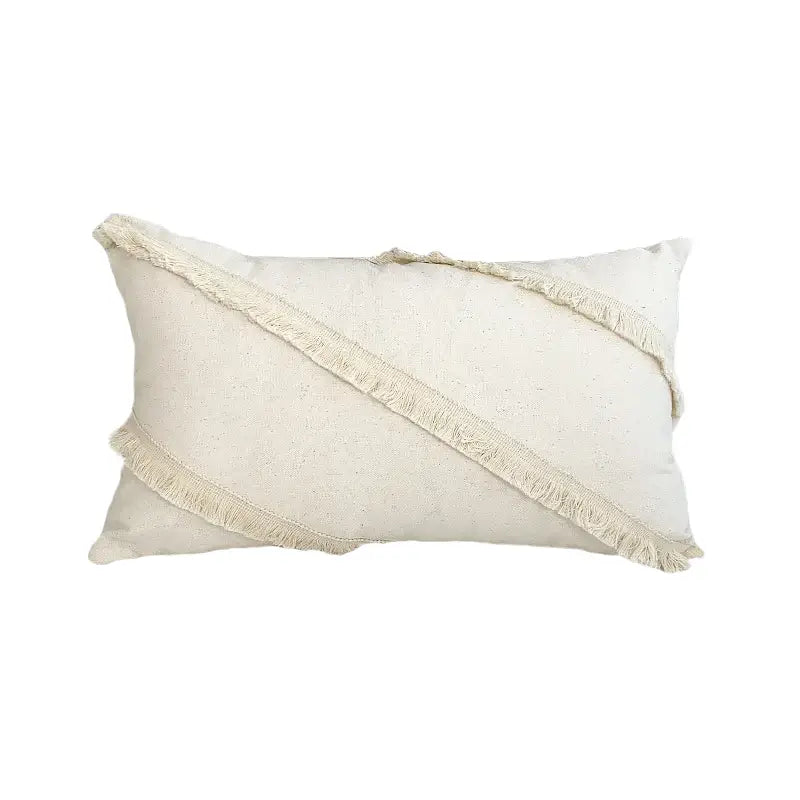 Cream-colored boho style cushion cover in natural linen with diagonal fringed stripes and tassels for living room decor