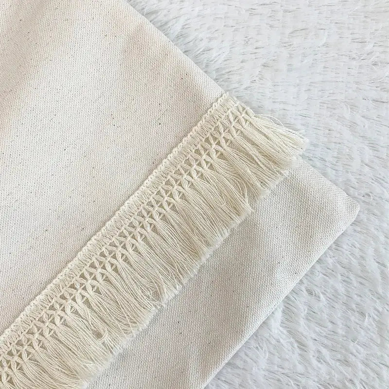 Cream-colored boho style cushion cover with delicate hand-crocheted fringe trim decorbites boho style living room decor