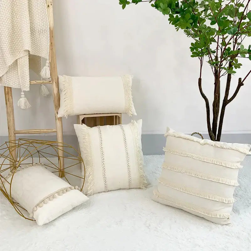 Cream-colored boho style linen cushion cover with fringed edges and decorative stitching for living room decor by decorbites boho style
