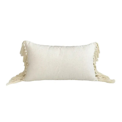 Cream-colored boho style linen cushion cover with textured fabric and tassels for living room decor by DecorBites