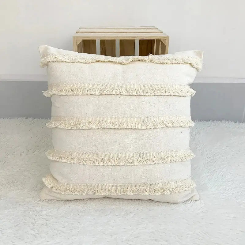 Boho style beige linen cushion cover with tassels featuring cream color and textured frayed fabric trim for decorbites decor