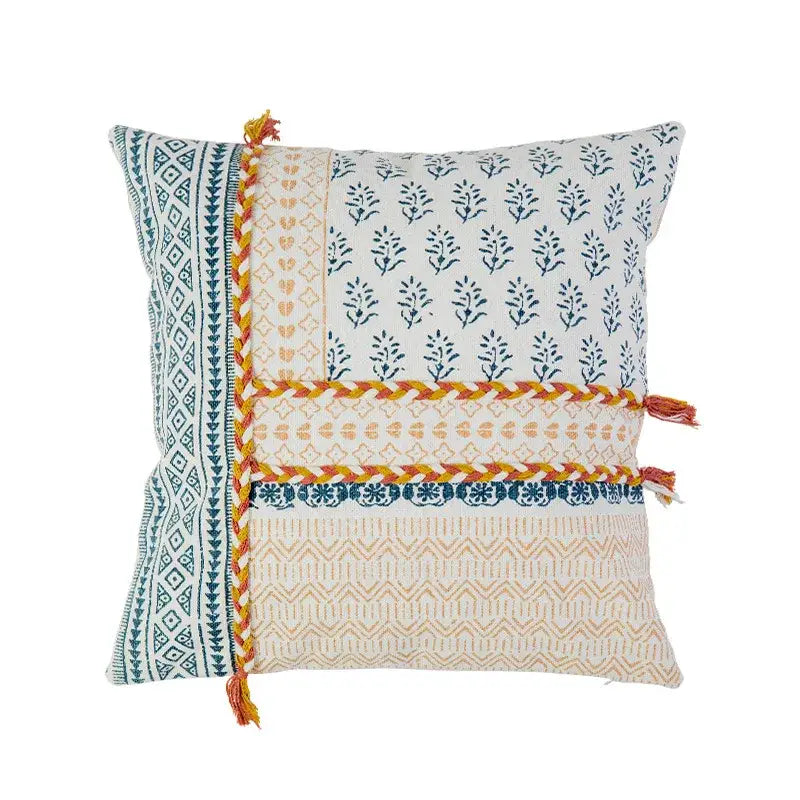Boho style cotton pillow cover with cream and mustard patchwork, blue botanical prints, and orange braided trim decorbites boho style