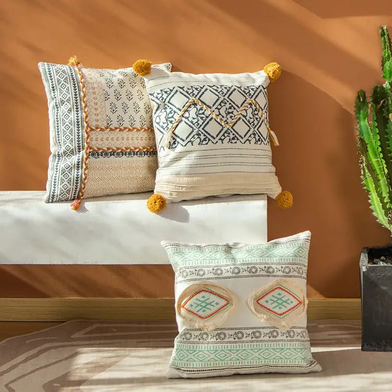 Three embroidered boho style cotton pillow covers in cream and mustard with tassels for living room decorbites decor