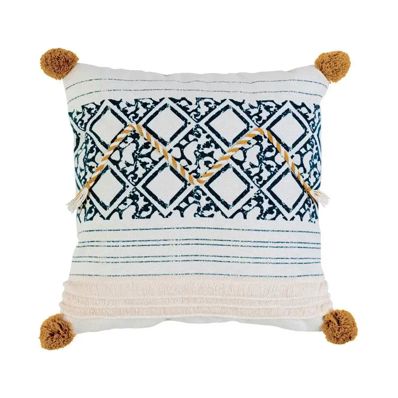 White throw pillow cover with navy geometric pattern cream fringe and tan pom-poms boho style cotton decorbites boho style