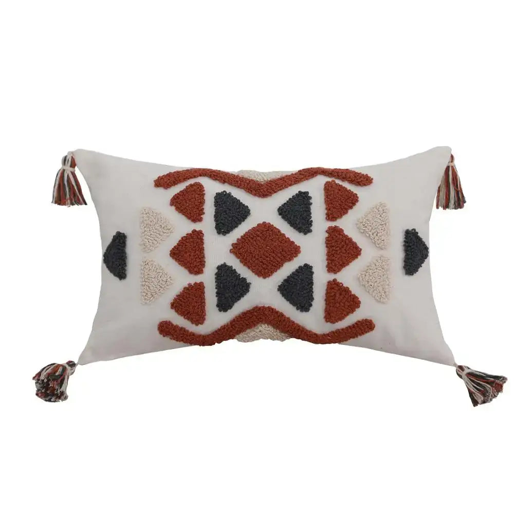 Cream-colored boho style embroidered pillow cover with rust and beige geometric pattern and tassels for decorbites decor
