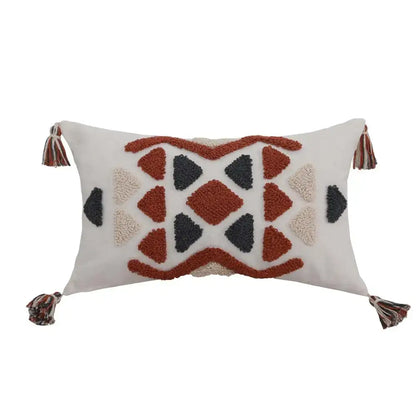 Cream-colored boho style embroidered pillow cover with rust and beige geometric pattern and tassels for decorbites decor