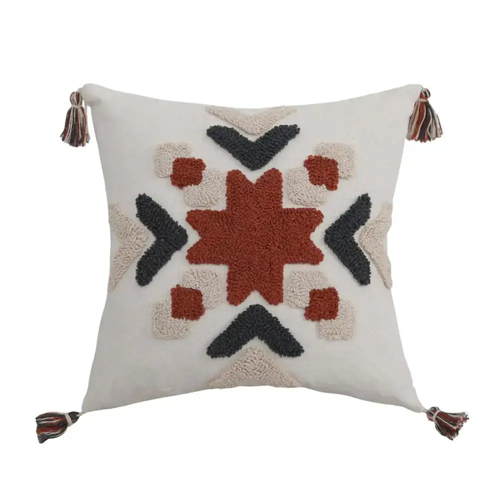 Cream-colored pillow cover with boho style embroidered rust geometric pattern and multicolored tassels decorbites boho style